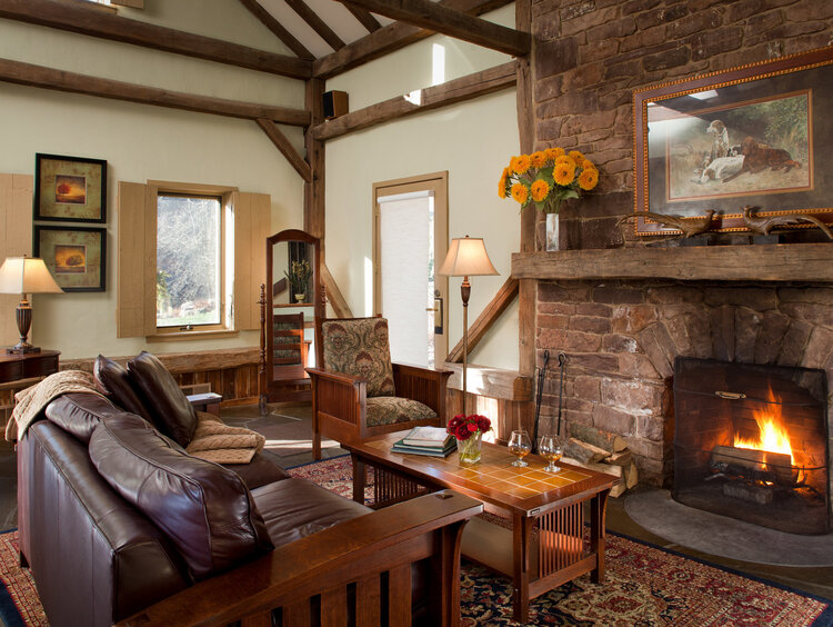 Interior of Garden cottage with couch and fireplace