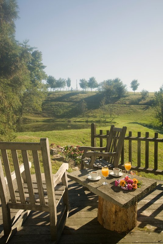 Patio with chairs and view of lawn